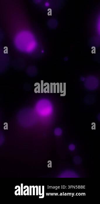 Abstract purple and magenta glowing bokeh lights floating against a ...