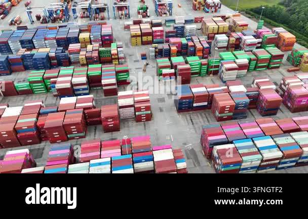 Expansive aerial view of a busy industrial port with colorful shipping ...