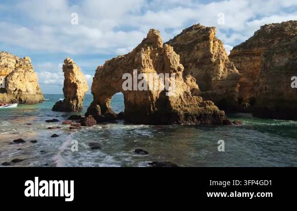 sunlit-limestone-cliffs-surround-the-ocean-cove-at-ponta-da-piedade-in