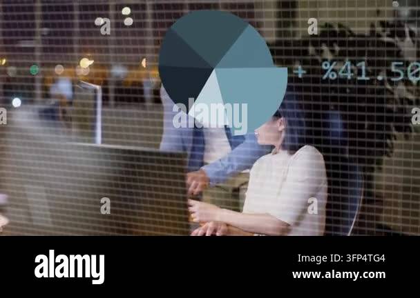 Glowing pie chart appearing, man leaning pointing while woman typing ...