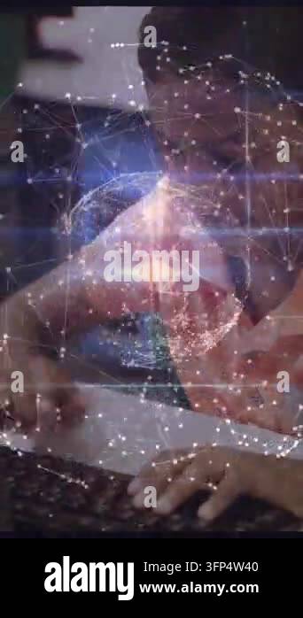 Vertical video: Boy typing on keys activating pulsing network globe ...