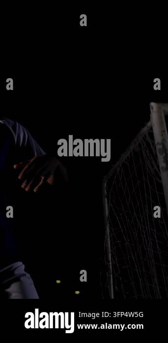 Vertical video: As adult male raising ball and reaching goalpost, graph ...