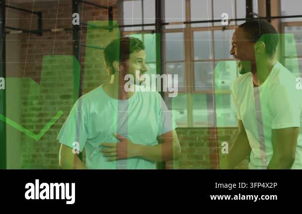 Two men talking in fitness studio, one touching abdomen and causing ...