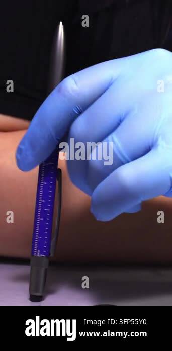 Vertical close-up shot of a doctor in blue gloves spinning a blue multi ...