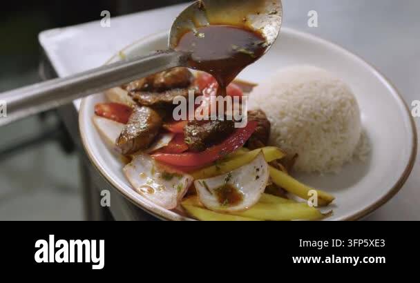 Pouring sauce over meat and vegetables with rice Stock Video Footage ...