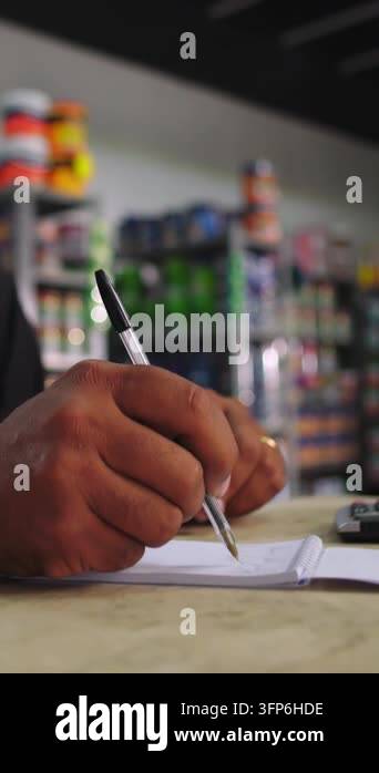 Pen Notepad Folder Vertical video showing close-up of a man's hands writing in a notepad ...