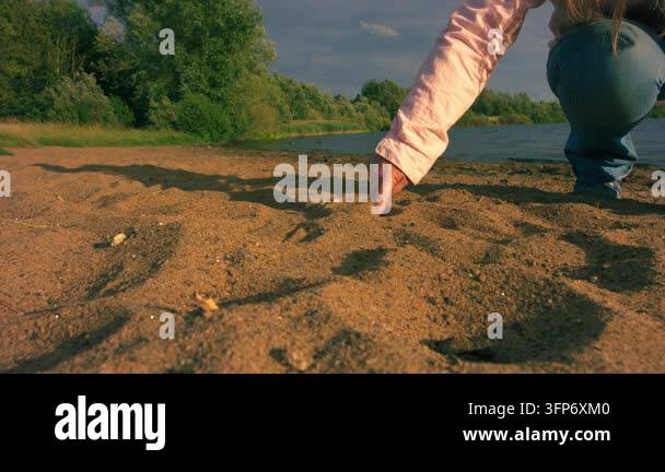 Medium Line Model Woman drawing a line in the sand at beach medium 4k slow motion ...