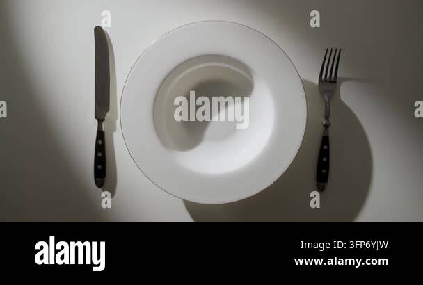 Restaurant Menu Matrix Examples Cinematic orbit around an empty elegant white plate with a knife and ...