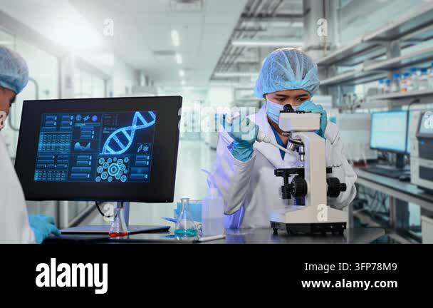 Two scientists in a modern laboratory are conducting research, one ...