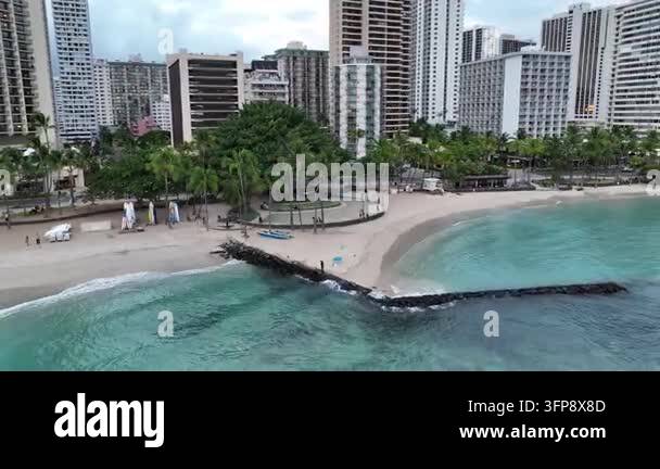 Aerial drone footage of a tropical beach with palm trees and high-rise ...