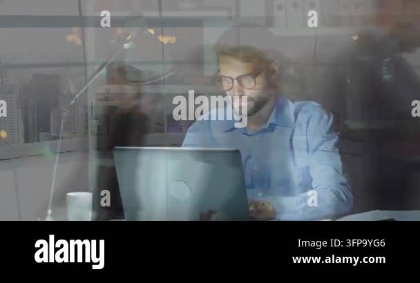 Seated man typing at laptop blurred staff passing forming layer ...
