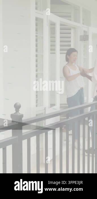 Vertical video: Man approaching handing keys to woman, key icon ...