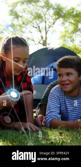 Vertical video: Girl pointing on grass, initiating AR network expanding ...
