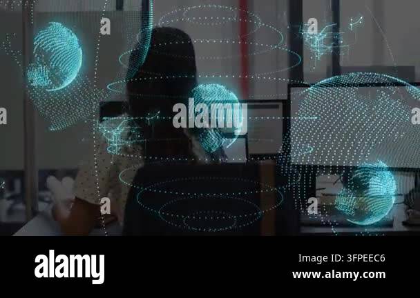Seated woman using mouse calling colleague reviewing data in tech ...