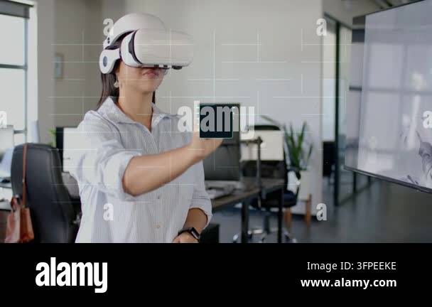 Woman wearing VR headset holding finger ahead selecting tech processor ...