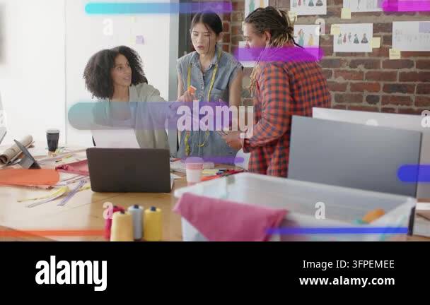 Seated woman handing printout, team checking tape and arranging fabrics ...