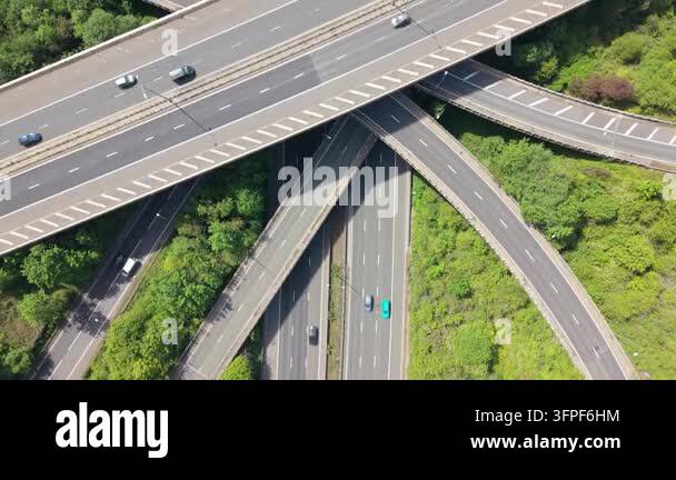 Vehicles drive on a sprawling highway interchange with multiple ...