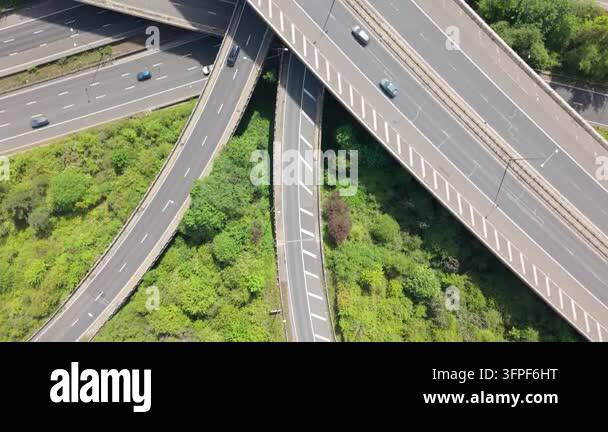An aerial perspective shows a complex network of highways. Cars move ...