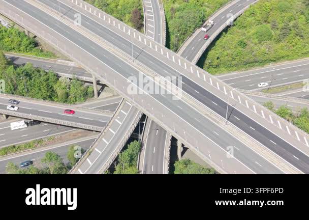 Overhead view of a busy highway interchange during daytime. Numerous ...