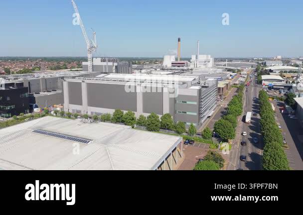 High angle look at a massive data center facility. Cars drive on the ...