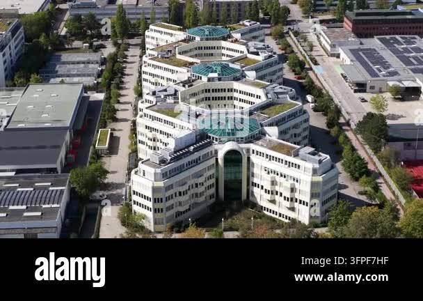 Aerial drone view of a modern X-shaped office complex in Munich ...