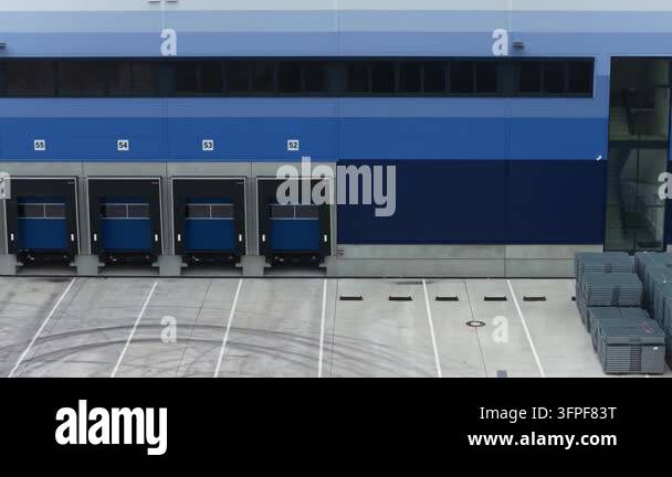 Loading Vehicle Vector Industrial building with a clean, blue facade and several numbered ...