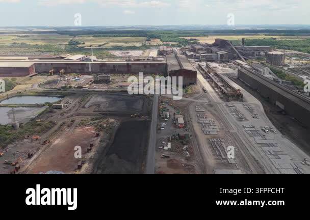 Vector Resolution Definition Panoramic view of a large steel mill facility under a clear sky ...