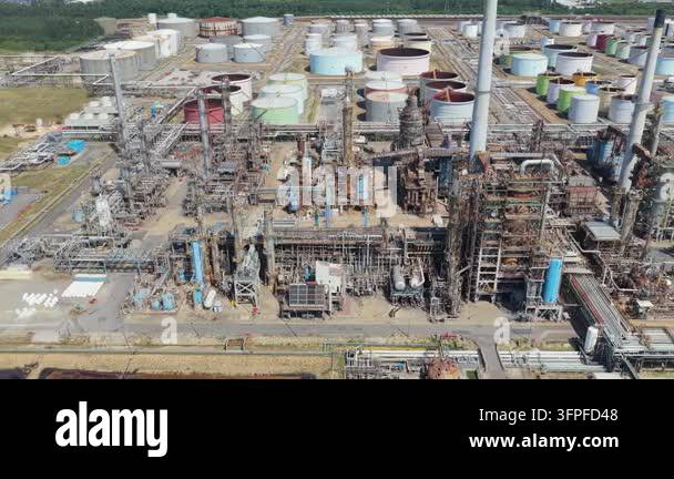 Daytime aerial view of a large oil refinery. It features many storage ...