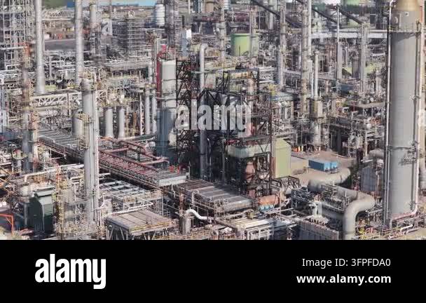 Expansive industrial chemical plant operates with numerous tall towers ...