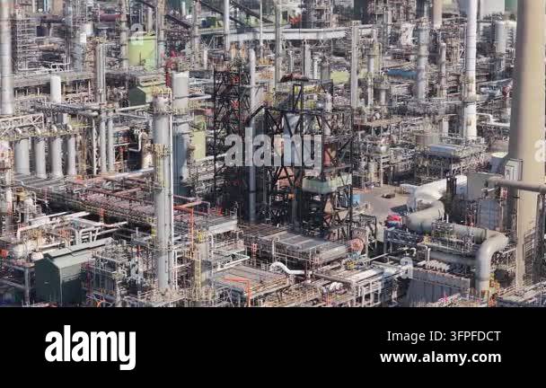 Vector Resolution Definition Aerial view shows a large industrial refinery during daylight. Numerous ...