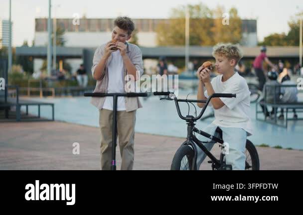 Two Fast Photo Frame Two happy friends laughing and eating burgers near a BMX bicycle and ...