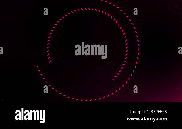 Dynamic pink dotted circles rotate on dark background for digital ...
