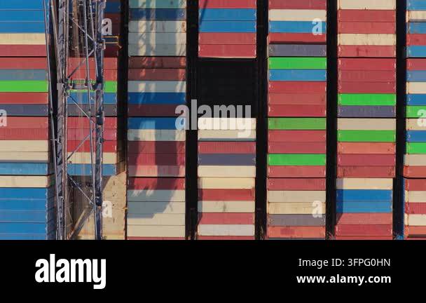 Stacks of multicolored steel cargo boxes fill the commercial harbor ...