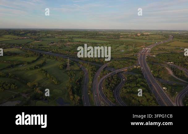 Aerial perspective of a multi-lane highway interchange in a green rural ...