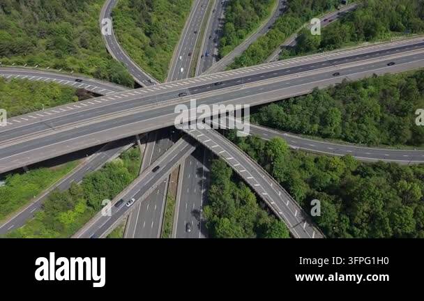 An aerial perspective captures a multi-level highway interchange with ...