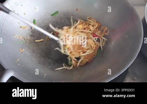 Notepad Clip Vector Cooking authentic Pad Thai noodles in a wok, stir-frying with a spatula ...
