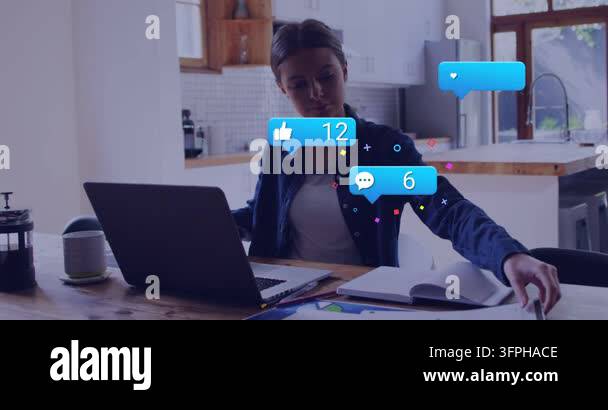Woman working at home table reaching for paper by laptop causing blue ...