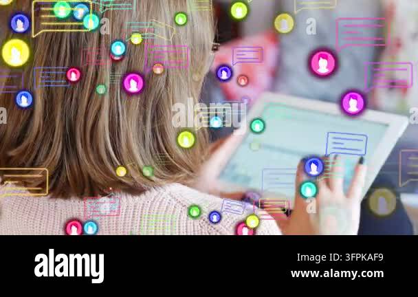Woman tapping tablet creating social icons swelling, swirling around ...