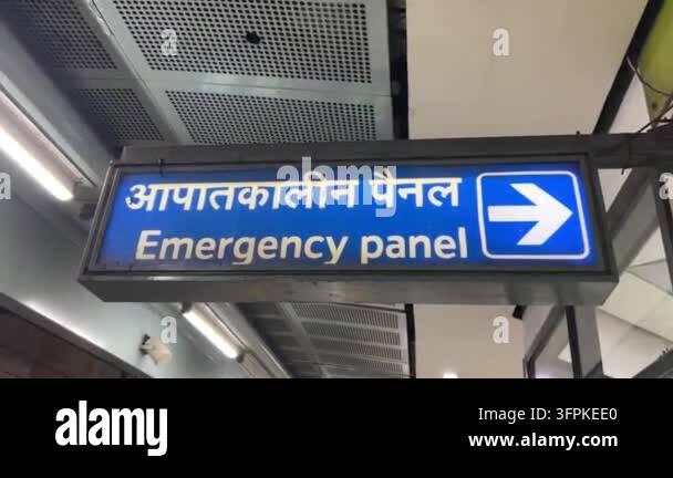 8 Sign Direction Emergency panel sign displayed in a public building with bilingual text ...