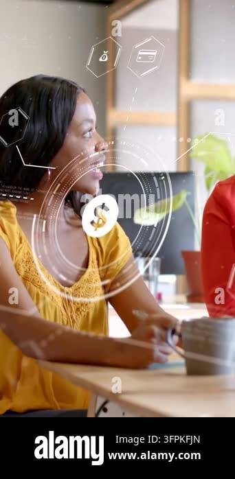 Vertical video: Woman in yellow turning to colleague, explaining ...