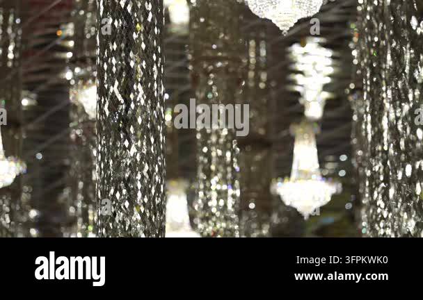 Intricate mirror mosaic pillars and glowing crystal chandeliers create ...