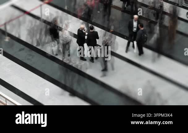 Two Fast Photo Frame Two people stand and talk while a blurred crowd moves rapidly around ...