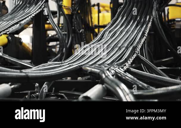 Close-up of multiple metal tubes and hydraulic lines installed inside ...
