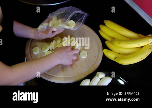 Simple Sign File Naturally sweet banana slices are prepared for desserts, smoothie bowls ...