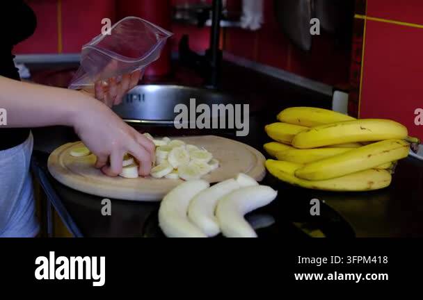 Simple Sign File Naturally sweet banana slices are prepared for desserts, smoothie bowls ...