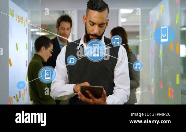 Man tapping tablet in office, causing blue icon net growing across ...