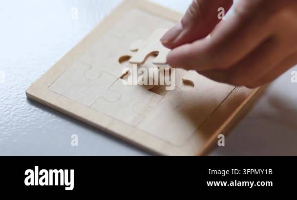 Problem Solving Is Logical Hand placing a wooden jigsaw puzzle piece on a board, problem solving ...