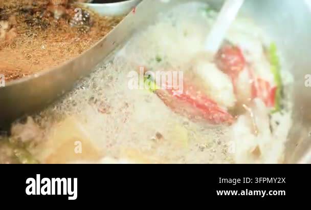 Boiling shabu hot pot with sliced meat and vegetables cooking in hot ...