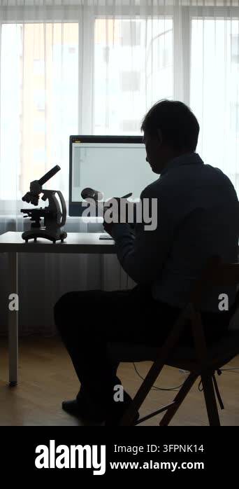 Vertical video scientist silhouette working on a research project ...