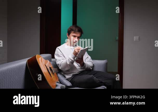 Notepad Clip Vector Young man sitting on a sofa, deeply focused and writing song lyrics in ...